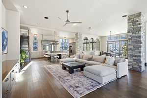 Living area featuring dark wood-type flooring, ceiling fan, and recessed lighting
