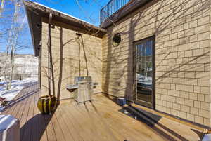 Snow covered deck with a grill