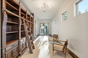 Sitting room featuring recessed lighting, light carpet, and a chandelier