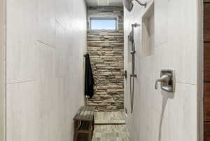 Bathroom featuring a tile shower