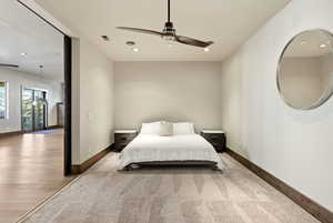 Bedroom with light carpet, recessed lighting, and a ceiling fan