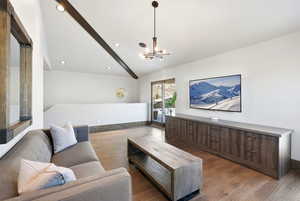 Living room with light wood-style floors and a chandelier