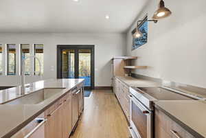 Kitchen with stainless steel electric range oven, open shelves, light wood-style floors, recessed lighting, and modern cabinets