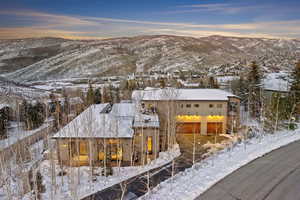 View of front of house featuring a mountain view and a balcony