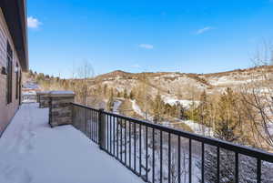 Snow covered back of property with a mountain view