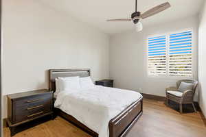 Bedroom with light wood finished floors and ceiling fan