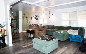 Living area featuring wood finished floors and beamed ceiling