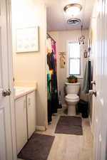 Full bathroom featuring vanity, curtained shower, and a decorative wall