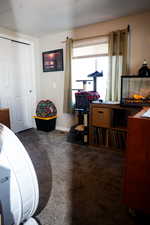 Bedroom featuring dark carpet and a closet