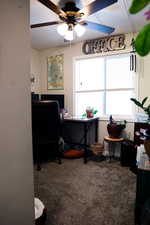 Carpeted office featuring ceiling fan
