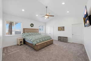 Primary bedroom with carpet floors, lofted ceiling, ceiling fan, a closet, and recessed lighting