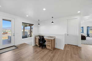 Office area featuring light wood-style flooring, recessed lighting, plenty of natural light, and built in study area