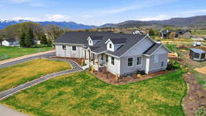 View of front of home with roof with shingles, covered porch, a mountain view, and board and batten siding