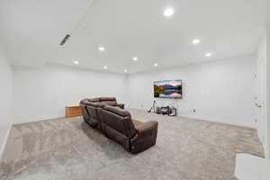 Family room area featuring recessed lighting and light colored carpet