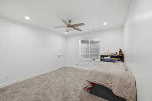 Bedroom with carpet floors, ceiling fan, and recessed lighting