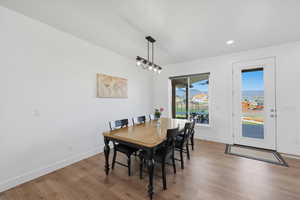 Dining area with light wood finished floors and recessed lighting