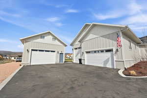 View of large attached garage and smaller detached garage with living quarters upstairs