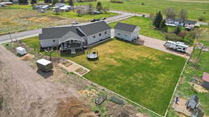 Aerial view of property and surrounding area, including shed and chicken coop
