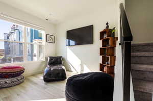Living area featuring light wood-type flooring and stairway