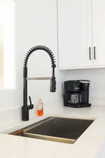 Kitchen view of white cabinets and light countertops