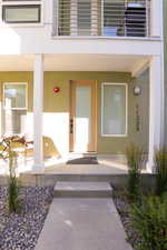View of exterior entry featuring stucco siding