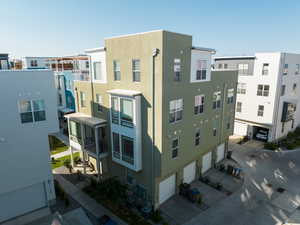 View of building exterior featuring a garage and driveway