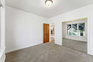 Unfurnished bedroom featuring carpet flooring and a closet