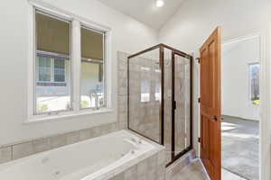 Bathroom with a shower stall, a whirlpool tub, light colored carpet, and light tile patterned flooring