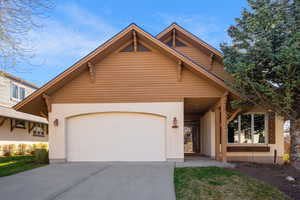 View of front of house with concrete driveway, a garage, and stucco siding
