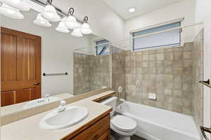 Bathroom featuring shower / tub combination and vanity
