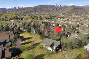 Aerial view of property's location featuring nearby suburban area and a mountainous background