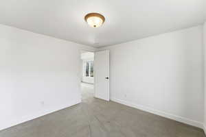 Unfurnished room featuring baseboards and carpet