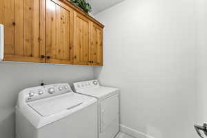 Laundry area with cabinet space and separate washer and dryer