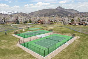 View of tennis court with a mountain view and a residential view