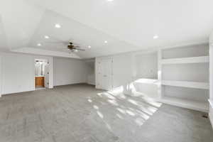 Bonus room featuring light carpet, built in shelves, a ceiling fan, and recessed lighting