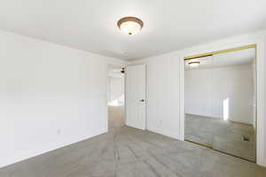 Unfurnished bedroom featuring light colored carpet and a closet