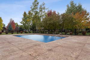 Community pool with a patio