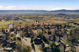 Aerial view of residential area featuring a mountainous background