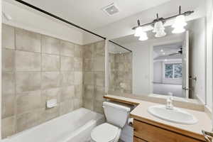 Full bath with vanity, bathing tub / shower combination, and ceiling fan