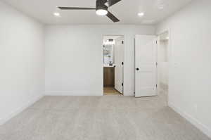Unfurnished bedroom with light colored carpet, ceiling fan, connected bathroom, and recessed lighting