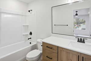Bathroom featuring vanity,  shower combination, and a ceiling fan