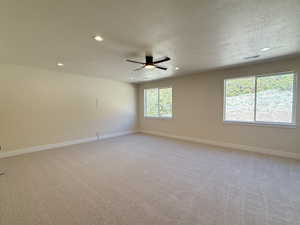Unfurnished room featuring light carpet, a textured ceiling, recessed lighting, and ceiling fan