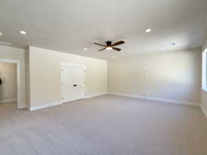 Unfurnished room featuring light carpet, ceiling fan, recessed lighting, and a textured ceiling