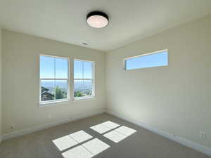 Unfurnished room with baseboards and carpet floors