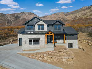 View of front of house featuring a standing seam roof, a porch, and a mountain view