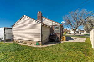 View of home's exterior featuring a gate and a chimney