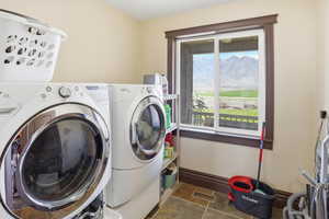 Laundry area featuring washing machine and clothes dryer and a mountain view