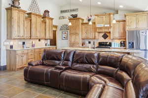 Living area with vaulted ceiling and recessed lighting