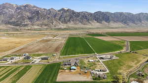 Aerial view of property's location with rural landscape, farmland, and a mountain backdrop