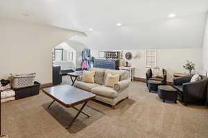 Loft with vaulted ceiling, carpet flooring, and recessed lighting